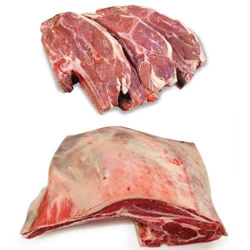 Raw pork ribs and pork shoulder meat on a white background