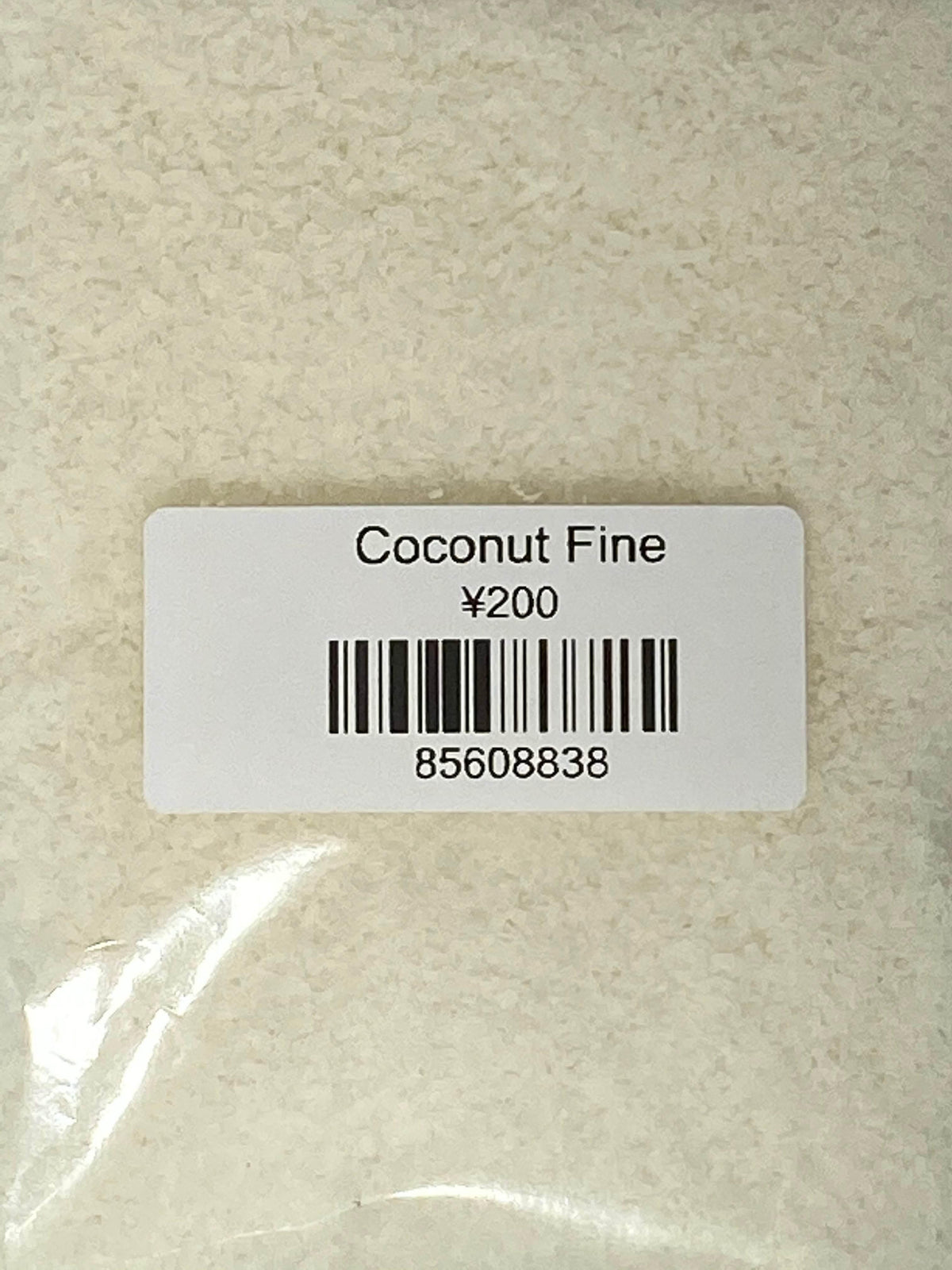 Clear plastic bag with fine coconut flakes labeled Coconut Fine priced ¥200 with barcode