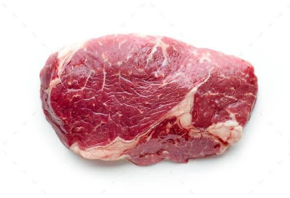 Raw fresh ribeye steak with marbled fat isolated on white background