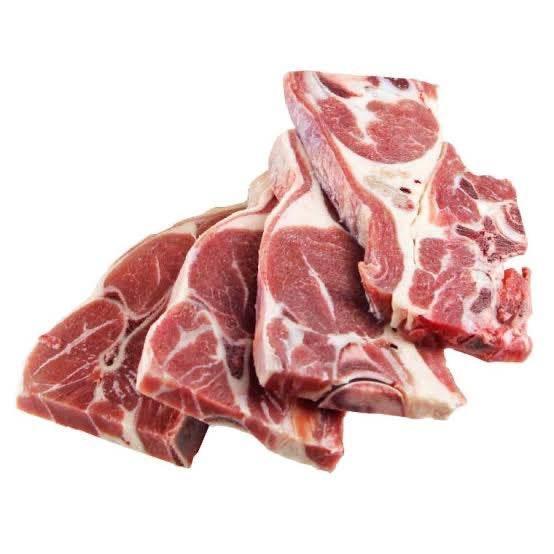 Four raw lamb chops with marbled fat on a white background