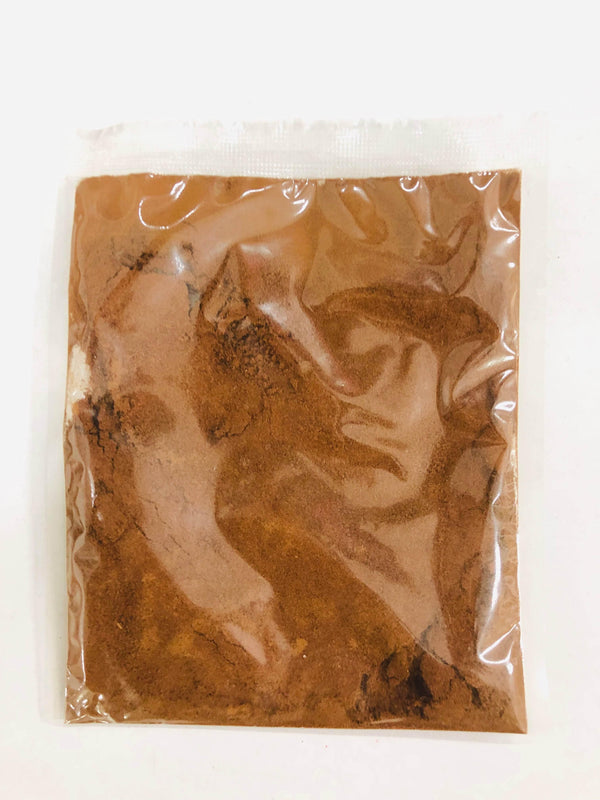 Transparent plastic packet filled with brown cocoa powder on white background