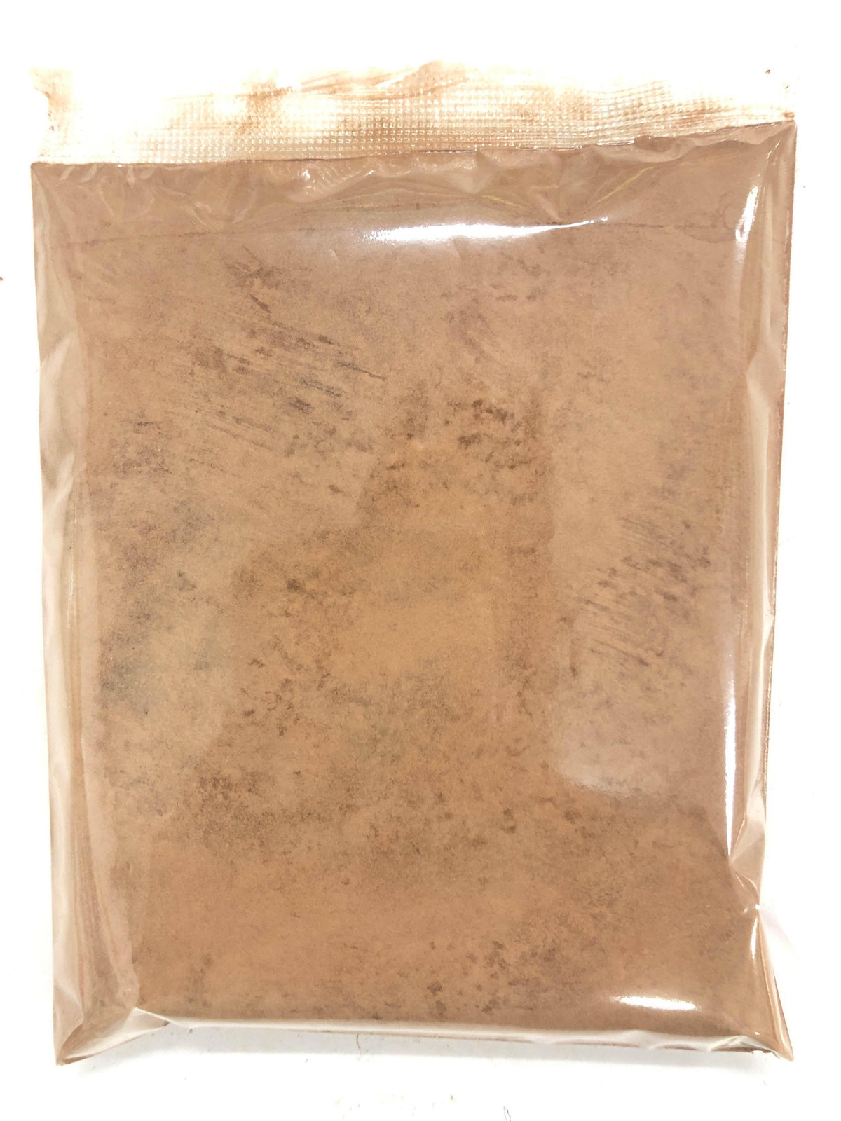 Transparent sealed plastic bag containing fine brown powder, isolated on white background