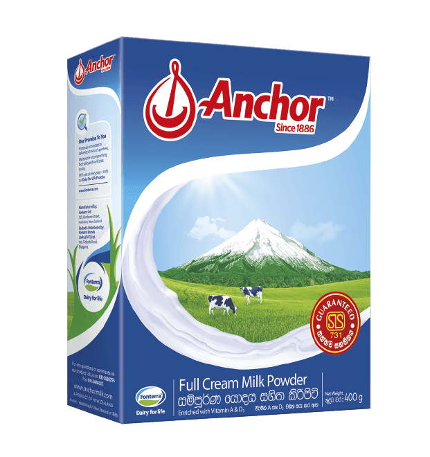 Anchor full cream milk powder box with green field, cows, and snowy mountain illustration