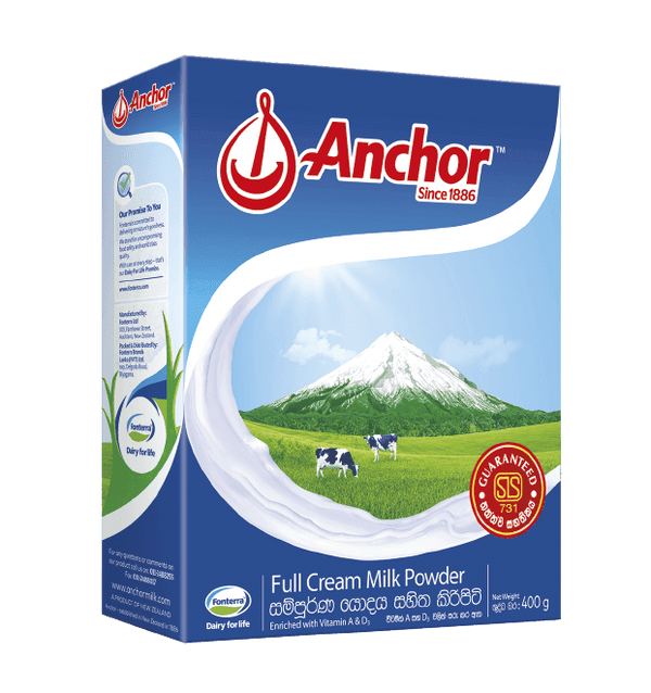Anchor full cream milk powder box with green field, cows, and snowy mountain illustration