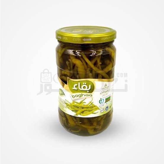 Jar of Baghaa pickled green chili peppers with gold lid on white background