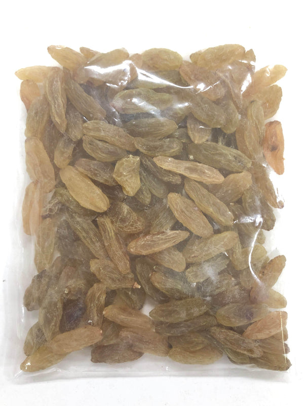 Transparent plastic bag filled with elongated golden brown raisins on white background