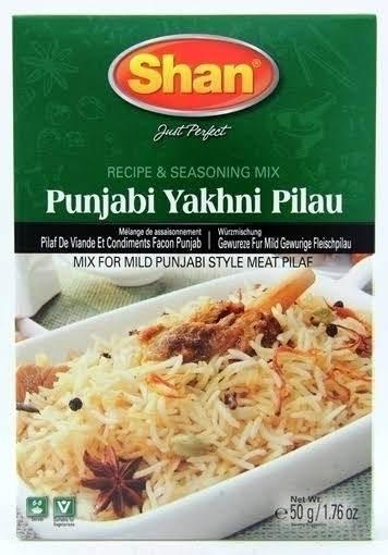 Shan Punjabi Yakhni Pilau seasoning mix package with a bowl of aromatic meat pilaf garnished with spices