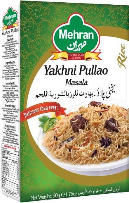 Mehran Yakhni Pullao Masala spice mix box with a plate of seasoned rice and aromatic spices on green background