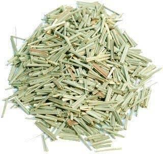 Pile of dried lemongrass stalks isolated on white background