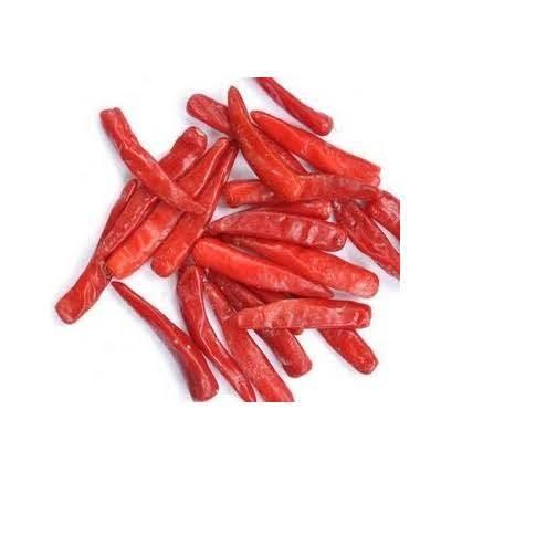 Pile of dried red chili peppers on white background