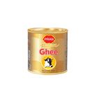 Tin of PRAN Premium Ghee with cow logo and gold-yellow label on white background
