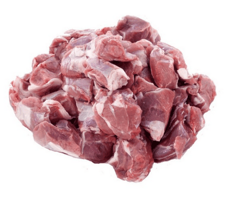 Fresh raw goat meat cuts piled on a white background for cooking