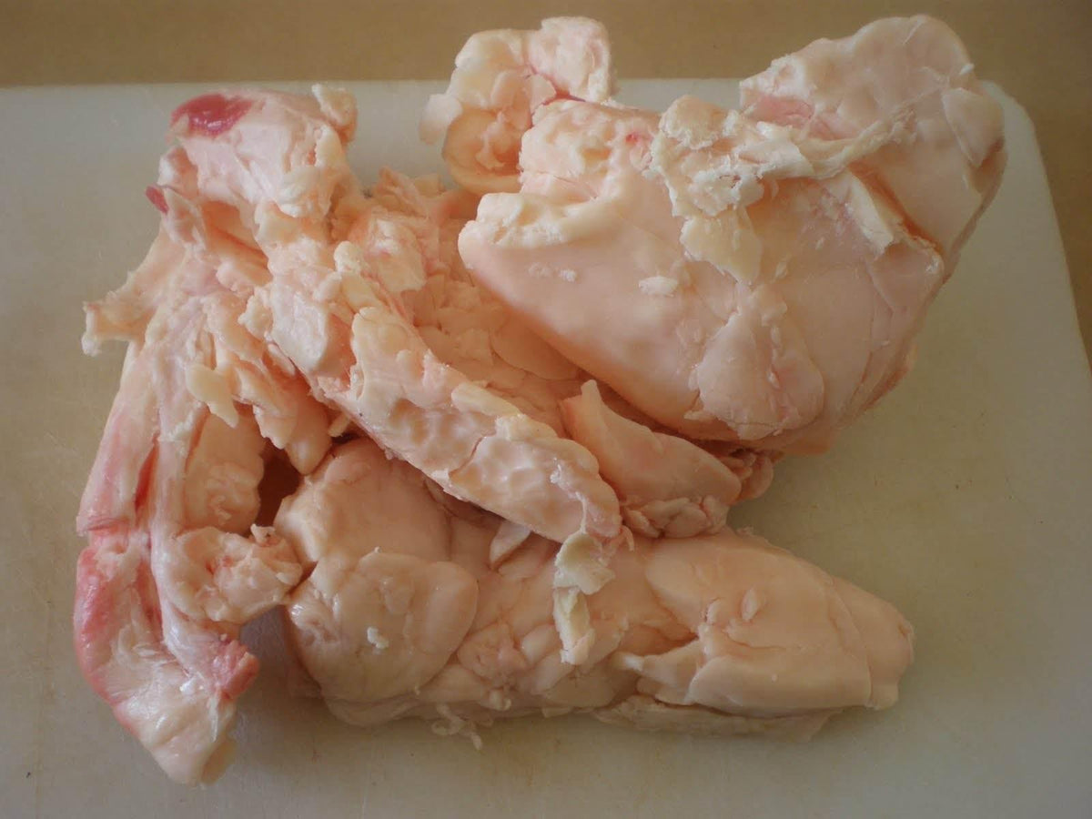 Raw suet fat pieces on a light surface for cooking or rendering