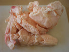 Raw suet fat pieces on a light surface for cooking or rendering